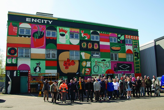 Green City members stood infront of freshly painted mural
